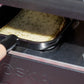 Raclette de Savoie à l'ail des ours, tranche qui fond sous l'appareil à raclette