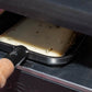 Raclette à la truffe, tranche qui fond sous l'appareil à raclette